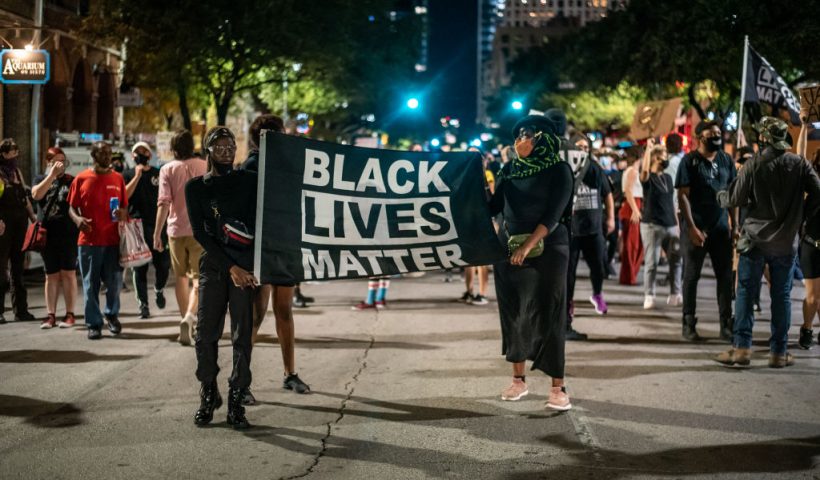 AUSTIN, TX - JULY 26: people march in the street after a vigil for Garrett Foster on July 26, 2020 in downtown Austin, Texas. Garrett Foster, 28, who was armed and participating in a Black Lives Matter protest, was shot and killed after a chaotic altercation with a motorist who allegedly drove into the crowd. The suspect, who has yet to be identified, was taken into custody. (Photo by Sergio Flores/Getty Images)