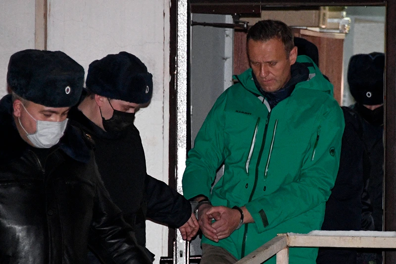 TOPSHOT-RUSSIA-POLITICS-OPPOSITION-NAVALNY
TOPSHOT - Opposition leader Alexei Navalny is escorted out of a police station on January 18, 2021, in Khimki, outside Moscow, following the court ruling that ordered him jailed for 30 days. Kremlin critic Alexei Navalny on Monday urged Russians to stage mass anti-government protests during a court hearing after his arrest on arrival in Moscow from Germany. (Photo by Alexander NEMENOV / AFP) (Photo by ALEXANDER NEMENOV/AFP via Getty Images)