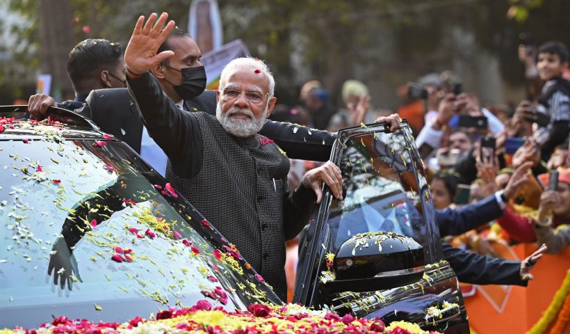 India's Prime Minister Narendra Modi (C) waves to his supporters during a roadshow ahead of the BJP national executive meet in New Delhi on January 16, 2023. (Photo by Sajjad HUSSAIN / AFP) (Photo by SAJJAD HUSSAIN/AFP via Getty Images)
