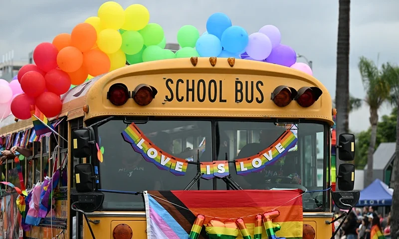 US-LGBTQ-PRIDE-PARADE A school bus adorned with rainbow colors is the YMCA entry to the 2023 LA Pride Parade on June 11, 2023 in Hollywood, California. The LA Pride Parade marks the last day of the three-day Los Angeles celebration of lesbian, gay, bisexual, transgender, and queer (LGBTQ) social and self-acceptance, achievements, legal rights, and pride. (Photo by Robyn Beck / AFP) (Photo by ROBYN BECK/AFP via Getty Images)