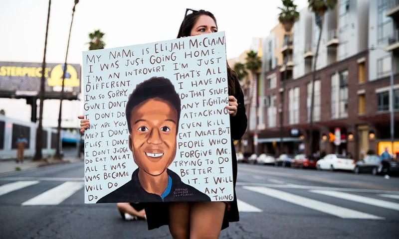 Laugh Factory Hosts Candlelight Vigil To Demand Justice For Elijah McClain WEST HOLLYWOOD, CALIFORNIA - AUGUST 24: A person holds a sign at a candlelight vigil to demand justice for Elijah McClain on the one year anniversary of his death at The Laugh Factory on August 24, 2020 in West Hollywood, California. (Photo by Rich Fury/Getty Images)