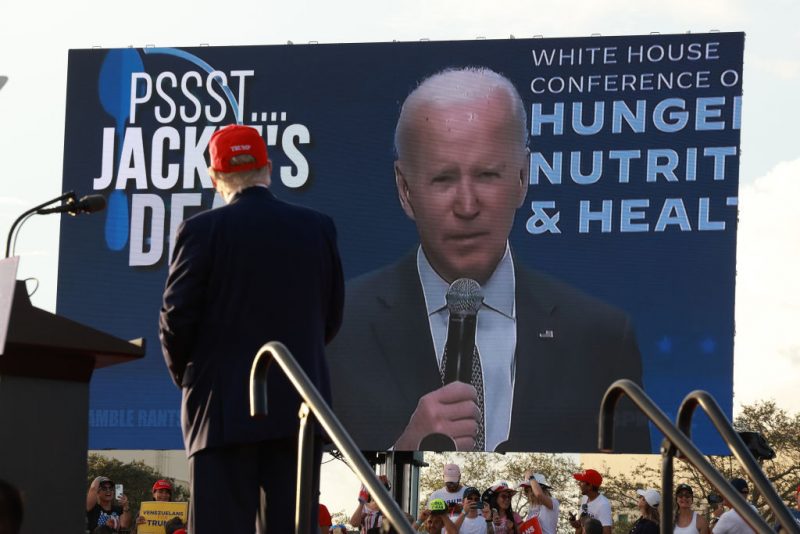 MIAMI, FLORIDA - NOVEMBER 06: Former U.S. President Donald Trump watches a video of President Joe Biden playing during a rally for Sen. Marco Rubio (R-FL) at the Miami-Dade Country Fair and Exposition on November 6, 2022 in Miami, Florida. Rubio faces U.S. Rep. Val Demings (D-FL) in his reelection bid in Tuesday's general election. (Photo by Joe Raedle/Getty Images)
