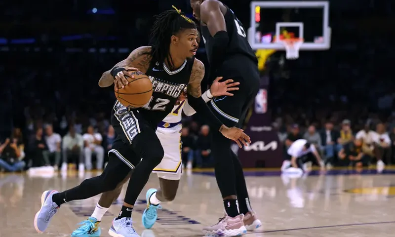 Ja Morant #12 of the Memphis Grizzlies dribbles off a screen during a 111-101 Los Angeles Lakers win in Game Three of the Western Conference First Round Playoffs at Crypto.com Arena on April 22, 2023 in Los Angeles, California. (Photo by Harry How/Getty Images)