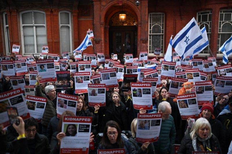 TOPSHOT - People hold up posters of the missing as they gather outside the Qatari Embassy in London on October 29, 2023, to demand the release of the estimated 230 hostages held in Gaza by Hamas after the attacks inside Israel on October 7. Thousands of civilians, both Palestinians and Israelis, have died since October 7, 2023, after Palestinian Hamas militants based in the Gaza Strip entered southern Israel in an unprecedented attack triggering a war declared by Israel on Hamas with retaliatory bombings on Gaza. (Photo by Justin TALLIS / AFP) (Photo by JUSTIN TALLIS/AFP via Getty Images)