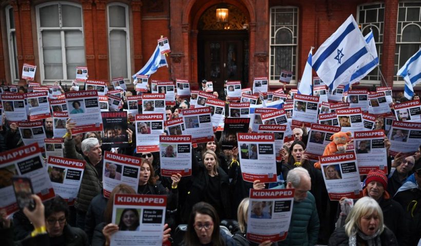 TOPSHOT - People hold up posters of the missing as they gather outside the Qatari Embassy in London on October 29, 2023, to demand the release of the estimated 230 hostages held in Gaza by Hamas after the attacks inside Israel on October 7. Thousands of civilians, both Palestinians and Israelis, have died since October 7, 2023, after Palestinian Hamas militants based in the Gaza Strip entered southern Israel in an unprecedented attack triggering a war declared by Israel on Hamas with retaliatory bombings on Gaza. (Photo by Justin TALLIS / AFP) (Photo by JUSTIN TALLIS/AFP via Getty Images)