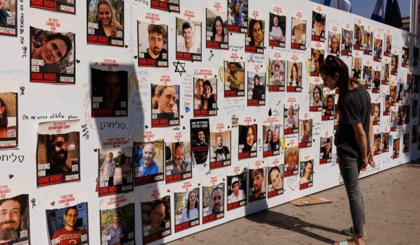 TEL AVIV, ISRAEL - OCTOBER 26: A member of the public looks at a wall displaying pictures of people still held hostage in Gaza, on October 26, 2023 in Tel Aviv, Israel. In the wake of the Oct. 7 attacks by Hamas that left an estimated 1,400 dead and 200 kidnapped, Israel launched a sustained bombardment of the Gaza Strip and threatened a ground invasion to vanquish the militant group that governs the Palestinian territory. But the fate of the hostages, Israelis and foreign nationals who are being held by Hamas in Gaza, as well as international pressure over the humanitarian situation in Gaza, have complicated Israel's military response to the attacks. A timeline for a proposed ground invasion remains unclear. (Photo by Dan Kitwood/Getty Images)