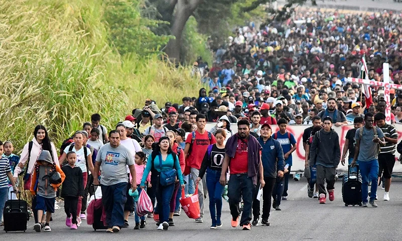Migrants take part in a caravan towards the border with the United States in Tapachula, Chiapas State, Mexico, on December 24, 2023. Mexican President Andres Manuel Lopez Obrador on December 22 said that his government would step up efforts to contain irregular migration flows. Lopez Obrador said the "extraordinary" migration situation would be the focus of talks with Secretary of State Antony Blinken and other senior US officials in Mexico City on Wednesday. (Photo by AFP) (Photo by STR/AFP via Getty Images)