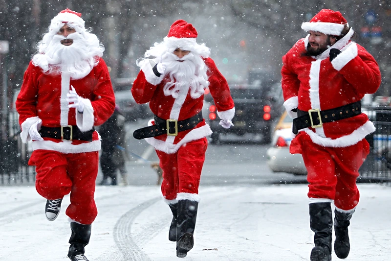 Revelers Dressed As Santa Take Part In Annual Bar Crawl Thru NYC
NEW YORK, NY - DECEMBER 14: Revelers dressed as Santa Claus run as the arrive at Tompkins Square Park to take part during the annual SantaCon bar crawl event on December 14, 2013 in New York City. The SantaCon annual event occurs worldwide in more than 300 cities in 44 countries. In New York some community groups have established a "Santa Free" zone that urges bars not to serve alcoholic beverages to people participating in order to dissuade incidents of public vomiting and urination in the streets. (Photo by Kena Betancur/Getty Images)