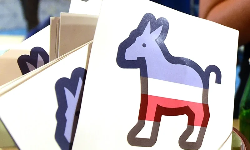 US-VOTE-DEMOCRATS-DEBATE Paddles with the Donkey logo are seen at the Facebook section ahead of the Democratic presidential debate at the Wynn Hotel in Las Vegas, Nevada on October 13, 2015, hours before the first Democratic Presidential Debate. After ignoring her chief rival for months, White House heavyweight contender Hillary Clinton steps into the ring Tuesday to confront independent Senator Bernie Sanders in their first Democratic debate of the 2016 primary cycle. Clinton will take center stage in Las Vegas joined by Sanders and three other hopefuls, and while there is unlikely to be a dramatic clash of personalities as seen in the first two Republican debates, the spotlight is likely to be on the top two candidates. The other three challengers -- former Maryland governor Martin O'Malley, ex-senator Jim Webb and former Rhode Island governor Lincoln Chafee -- will try to generate breakout moments to show they are electable alternatives to Clinton. AFP PHOTO / FREDERIC J. BROWN (Photo credit should read FREDERIC J. BROWN/AFP via Getty Images)