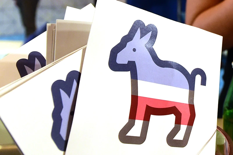 US-VOTE-DEMOCRATS-DEBATE
Paddles with the Donkey logo are seen at the Facebook section ahead of the Democratic presidential debate at the Wynn Hotel in Las Vegas, Nevada on October 13, 2015, hours before the first Democratic Presidential Debate. After ignoring her chief rival for months, White House heavyweight contender Hillary Clinton steps into the ring Tuesday to confront independent Senator Bernie Sanders in their first Democratic debate of the 2016 primary cycle. Clinton will take center stage in Las Vegas joined by Sanders and three other hopefuls, and while there is unlikely to be a dramatic clash of personalities as seen in the first two Republican debates, the spotlight is likely to be on the top two candidates. The other three challengers -- former Maryland governor Martin O'Malley, ex-senator Jim Webb and former Rhode Island governor Lincoln Chafee -- will try to generate breakout moments to show they are electable alternatives to Clinton. AFP PHOTO / FREDERIC J. BROWN (Photo credit should read FREDERIC J. BROWN/AFP via Getty Images)