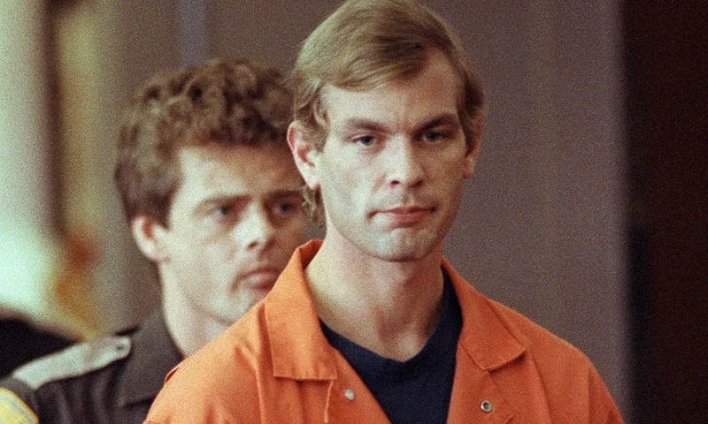 Suspected serial killer Jeffrey L. Dahmer enters t MILWAUKEE, WI - AUGUST 6: Suspected serial killer Jeffrey L. Dahmer enters the courtroom of judge Jeffrey A. Wagner 06 August 1991. Dahmer has been charged with eight additional counts of first-degree murder, bringing the number of homicides he is charged with to 12. The judge increased Dahmer's bail to five million dollars. He was sentenced to fifteen consecutive life terms or a total of 957 years in prison. Dahmer was killed by a fellow prisoner, Christopher Scarver, 28 November 1994 at Columbia Correctional Institution, Portage, Wisconsin. (FILM) (Photo credit should read EUGENE GARCIA/AFP via Getty Images)