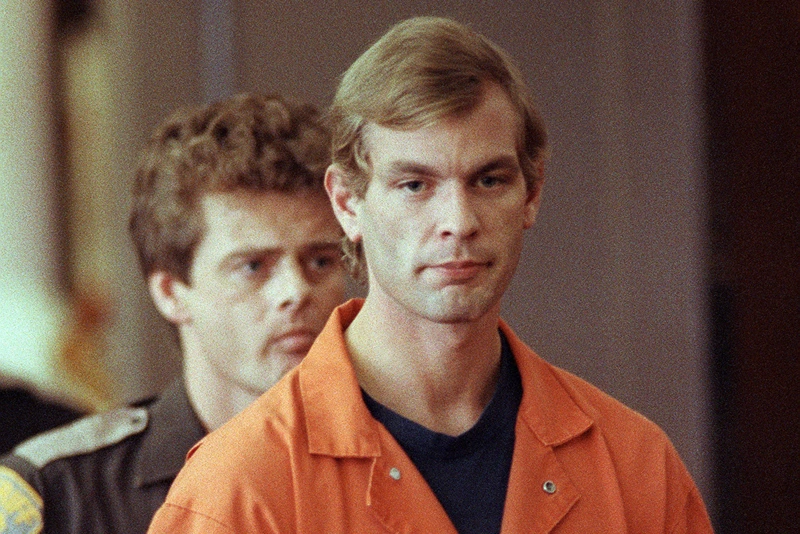 Suspected serial killer Jeffrey L. Dahmer enters t
MILWAUKEE, WI - AUGUST 6: Suspected serial killer Jeffrey L. Dahmer enters the courtroom of judge Jeffrey A. Wagner 06 August 1991. Dahmer has been charged with eight additional counts of first-degree murder, bringing the number of homicides he is charged with to 12. The judge increased Dahmer's bail to five million dollars. He was sentenced to fifteen consecutive life terms or a total of 957 years in prison. Dahmer was killed by a fellow prisoner, Christopher Scarver, 28 November 1994 at Columbia Correctional Institution, Portage, Wisconsin. (FILM) (Photo credit should read EUGENE GARCIA/AFP via Getty Images)