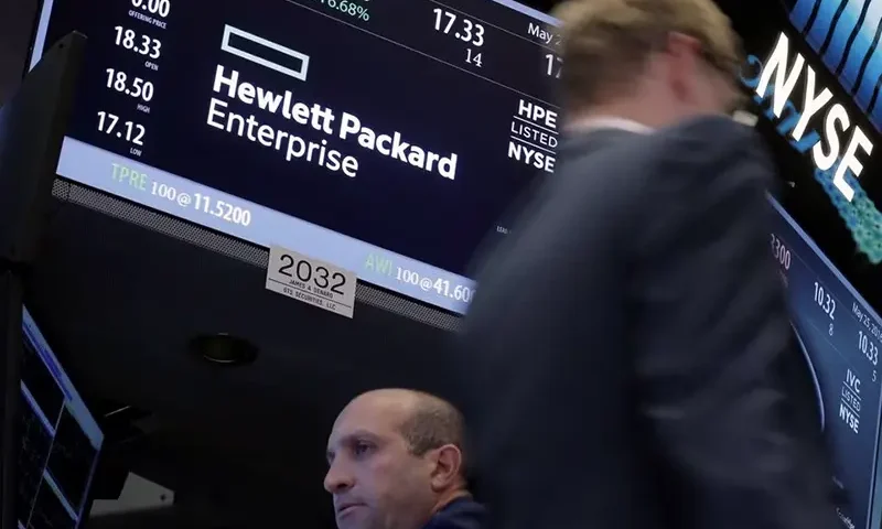 A trader passes by the post where Hewlett Packard Enterprise Co., is traded on the floor of the New York Stock Exchange (NYSE) in New York City, U.S., May 25, 2016. REUTERS/Brendan McDermid/File Photo