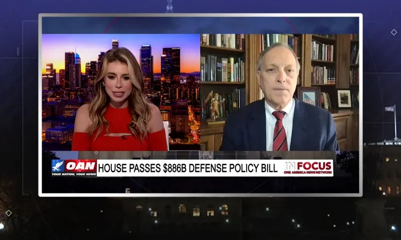 Video still from In Focus on One America News Network showing a split screen of the host on the left side, and on the right side is the guest, Rep. Andy Biggs.
