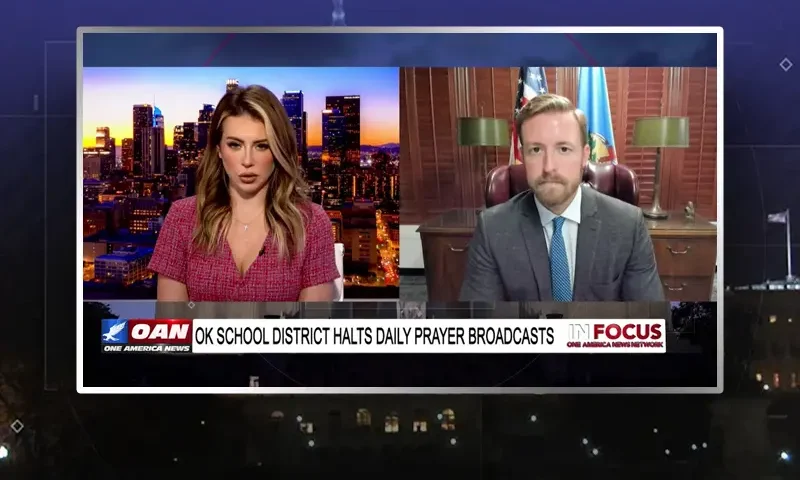 Video still from In Focus on One America News Network showing a split screen of the host on the left side, and on the right side is the guest, Ryan Walters.