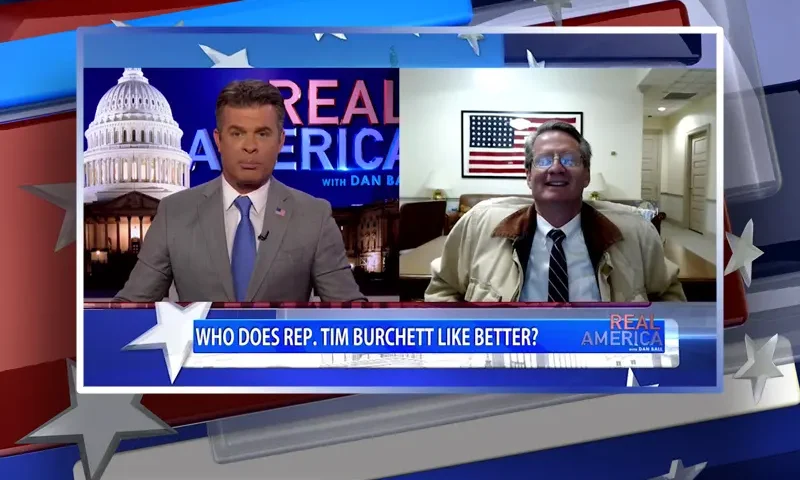 Video still from Real America on One America News Network showing a split screen of the host on the left side, and on the right side is the guest, Rep. Tim Burchett.