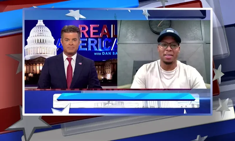 Video still from Real America on One America News Network showing a split screen of the host on the left side, and on the right side is the guest, Anthony Watson.