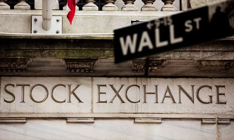 A street sign for Wall Street hangs in front of the New York Stock Exchange May 8, 2013. REUTERS/Lucas Jackson