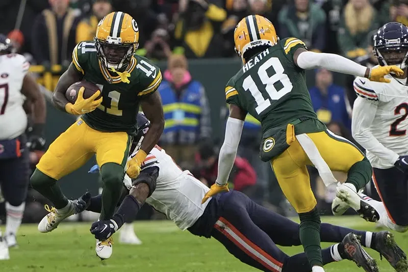 Green Bay Packers wide receiver Jayden Reed (11) makes a catch past Chicago Bears safety Eddie Jackson (4) during the first quarter at Lambeau Field. Mandatory Credit: Mark Hoffman-USA TODAY Sports