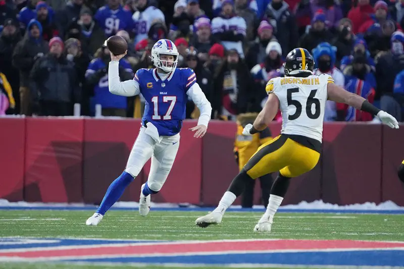 Buffalo Bills quarterback Josh Allen (17) looks the play th ball pressured by Pittsburgh Steelers linebacker Alex Highsmith (56) in the first quarter in a 2024 AFC wild card game at Highmark Stadium. Mandatory Credit: Kirby Lee-USA TODAY Sports