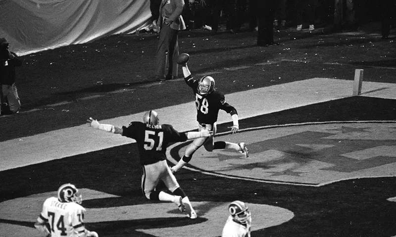 Squirek (58) celebrates after returning his interception for a touchdown in Super Bowl XIII against the Washington Redskins on Jan. 23, 1984. (Photo via; AP/FILE)