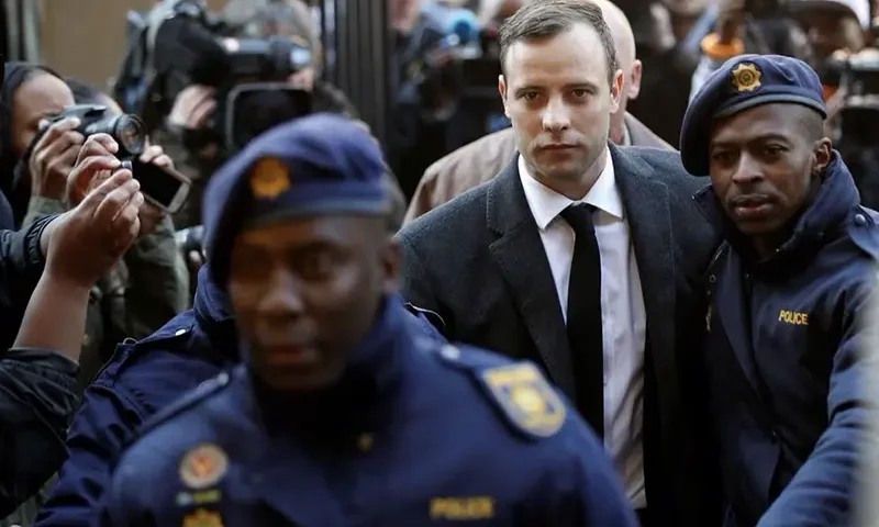 Olympic and Paralympic track star Oscar Pistorius is escorted by police officers as he arrives for his sentencing for the 2013 murder of his girlfriend Reeva Steenkamp, at North Gauteng High Court in Pretoria, South Africa July 6, 2016. REUTERS/Siphiwe Sibeko/File Photo