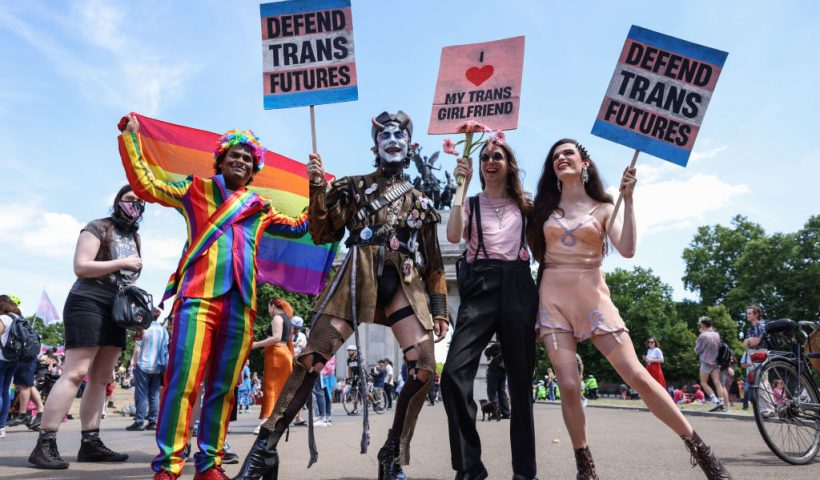 LONDON, ENGLAND - JULY 09: Demonstrators pose holding placards ahead of the London Trans Pride protest on July 9, 2022 in London, England. Trans rights activists took to the streets of central London this weekend to march for the fourth year under the slogan, Pride is a Protest at Trans+ Pride. (Photo by Hollie Adams/Getty Images)