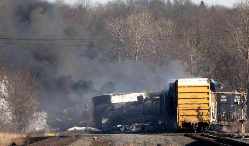 Smoke rises from a derailed cargo train in East Palestine, Ohio, on February 4, 2023. - The train accident sparked a massive fire and evacuation orders, officials and reports said Saturday. No injuries or fatalities were reported after the 50-car train came off the tracks late February 3 near the Ohio-Pennsylvania state border. The train was shipping cargo from Madison, Illinois, to Conway, Pennsylvania, when it derailed in East Palestine, Ohio. (Photo by DUSTIN FRANZ / AFP) (Photo by DUSTIN FRANZ/AFP via Getty Images)