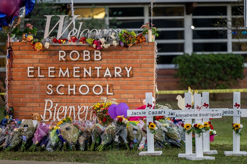 Mass Shooting At Elementary School In Uvalde, Texas Leaves At Least 21 Dead
UVALDE, TEXAS - MAY 26: A memorial is seen surrounding the Robb Elementary School sign following the mass shooting at Robb Elementary School on May 26, 2022 in Uvalde, Texas. According to reports, 19 students and 2 adults were killed, with the gunman fatally shot by law enforcement. (Photo by Brandon Bell/Getty Images)