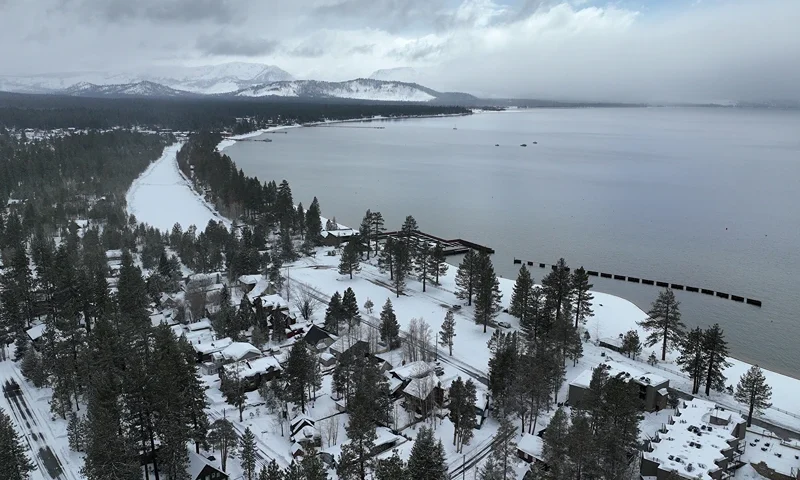 SOUTH LAKE TAHOE, CALIFORNIA - MARCH 21: In an aerial view, snow covers the banks of Lake Tahoe on March 21, 2023 in South Lake Tahoe, California. As a 12th atmospheric river hits California, the Lake Tahoe region is getting more snow. According to the UC Berkeley Central Sierra Snow Lab, this snow season has become the second snowiest season on record since the lab first started keeping records 77 years ago. More than 56.4 feet of snow has fallen in the Sierras this season surpassing the storm of 1982-83 which had 55.9 feet. (Photo by Justin Sullivan/Getty Images)