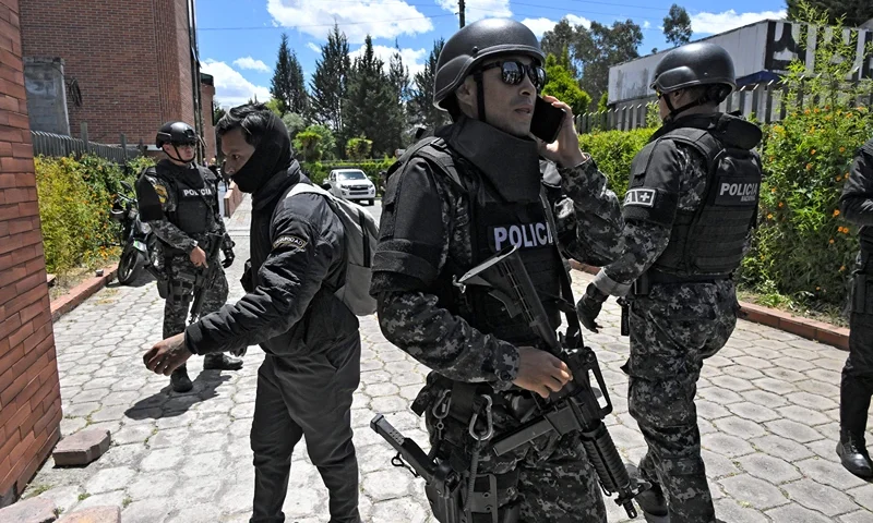 TOPSHOT - Police officers stand guard at the Vertical Cemetery before the funeral of slain Ecuadorean presidential candidate Fernando Villavicencio, a day after his assassination, in Quito, on August 10, 2023. Villavicencio, the second most popular candidate in the presidential race according to recent opinion polls, was shot dead while leaving a rally in the nation's capital on Wednesday, prompting President Guillermo Lasso to declare a state of emergency and blame the assassination on organized crime. Villavicencio, a 59-year-old anti-corruption crusader who had complained of receiving threats, was murdered as he was leaving a stadium in Quito after holding a campaign rally, officials said. (Photo by Rodrigo BUENDIA / AFP) (Photo by RODRIGO BUENDIA/AFP via Getty Images)