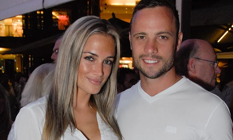 A picture taken on January 26, 2013 shows Olympian sprinter Oscar Pistorius posing next to his girlfriend Reeva Steenkamp at Melrose Arch in Johannesburg. South Africa's Olympic sprinter Oscar "Blade Runner" Pistorius was taken into police custody on February 14, 2013, after allegedly shooting dead his model girlfriend having mistaken her for an intruder at his upscale home. AFP PHOTO / WALDO SWIEGERS (Photo credit should read WALDO SWIEGERS/AFP via Getty Images)
