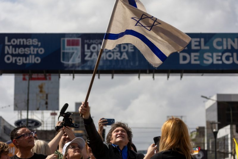 BUENOS AIRES, ARGENTINA - OCTOBER 16: Presidential candidate Javier Milei of La Libertad Avanza waves a flag of Israel during a rally on October 16, 2023 in Buenos Aires, Argentina. (Photo by Tomas Cuesta/Getty Images)