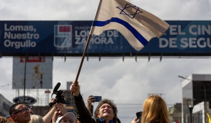 BUENOS AIRES, ARGENTINA - OCTOBER 16: Presidential candidate Javier Milei of La Libertad Avanza waves a flag of Israel during a rally on October 16, 2023 in Buenos Aires, Argentina. (Photo by Tomas Cuesta/Getty Images)