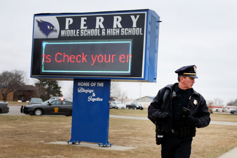 PERRY, IOWA - JANUARY 04: A police officer stands guard outside the Perry Middle School and High School complex following a school shooting on January 04, 2024 in Perry, Iowa. Students were returning to classes today following the holiday break. (Photo by Scott Olson/Getty Images)