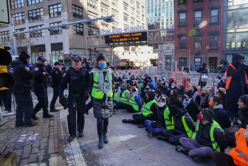 Protesters against the war in Gaza are arrested for blocking traffic at the entrance to the Holland Tunnel on January 8, 2024 in New York. (Photo by Bryan R. Smith / AFP) (Photo by BRYAN R. SMITH/AFP via Getty Images)