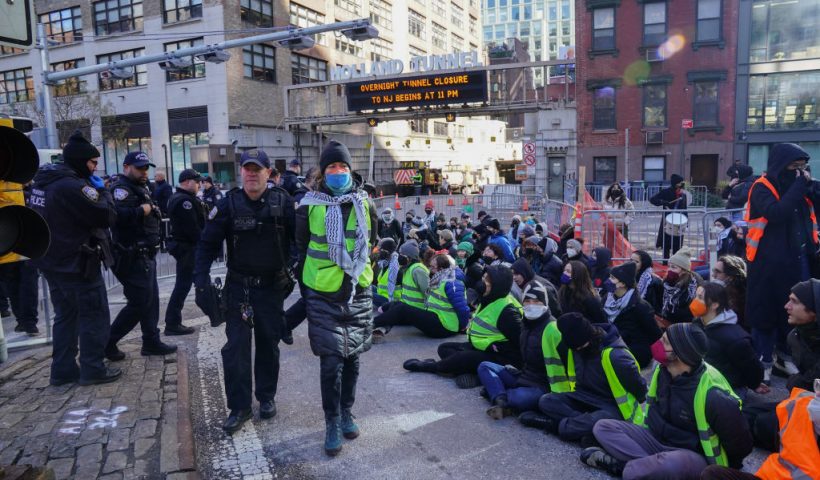 Protesters against the war in Gaza are arrested for blocking traffic at the entrance to the Holland Tunnel on January 8, 2024 in New York. (Photo by Bryan R. Smith / AFP) (Photo by BRYAN R. SMITH/AFP via Getty Images)