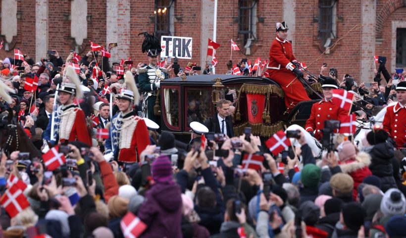 COPENHAGEN, DENMARK - JANUARY 14: The carriage of Queen Margrethe II of Denmark arrives as crowds of people wave Danish flags ahead the proclamation of Crown Prince as new Danish King Frederik X on January 14, 2024 in Copenhagen, Denmark. King Frederik X is succeeding Queen Margrethe II, who is stepping down after reigning for 51 years. (Photo by Sean Gallup/Getty Images)