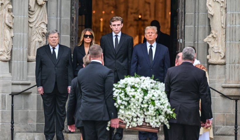 Former US President Donald Trump (center right) stands with his wife Melania Trump (2L) their son Barron Trump (center left) and father-in-law Viktor Knavs, as the coffin carrying the remains of Amalija Knavs, the former first lady's mother, is carried into the Church of Bethesda by the Sea for her funeral, in Palm Beach, Florida, on January 18, 2024. Former first lady Melania Trump's mother Amalija Knavs, 78, died January 9, 2024 in Miami following an undisclosed illness. (Photo by GIORGIO VIERA / AFP) (Photo by GIORGIO VIERA/AFP via Getty Images)