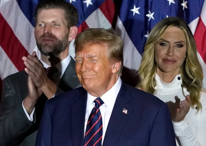 Republican presidential hopeful and former US President Donald Trump looks on, flanked by son Eric Trump (L) and daughter-in-law Lara Trump, during an Election Night Party in Nashua, New Hampshire, on January 23, 2024. Donald Trump won the key New Hampshire primary Tuesday, moving him ever closer to locking in the Republican presidential nomination and securing an extraordinary White House rematch with Joe Biden. (Photo by TIMOTHY A. CLARY / AFP) (Photo by TIMOTHY A. CLARY/AFP via Getty Images)