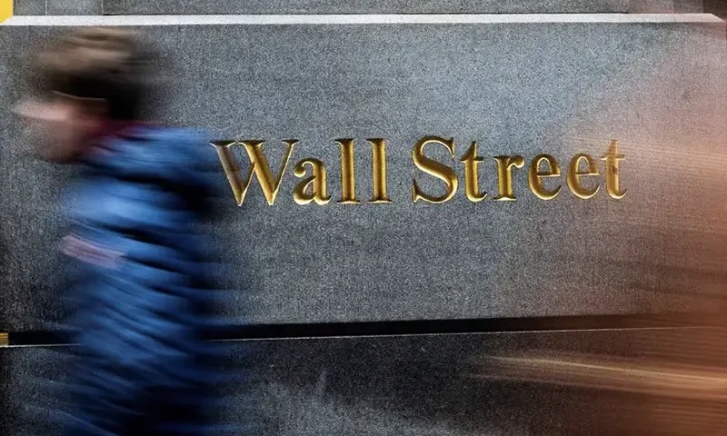 People walk around the New York Stock Exchange in New York, U.S., December 29, 2023. REUTERS/Eduardo Munoz/File Photo