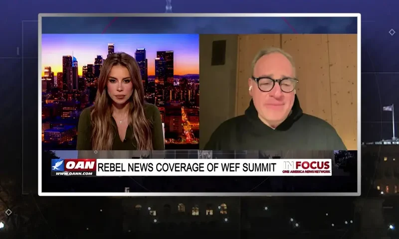Video still from In Focus on One America News Network showing a split screen of the host on the left side, and on the right side is the guest, Ezra Levant.