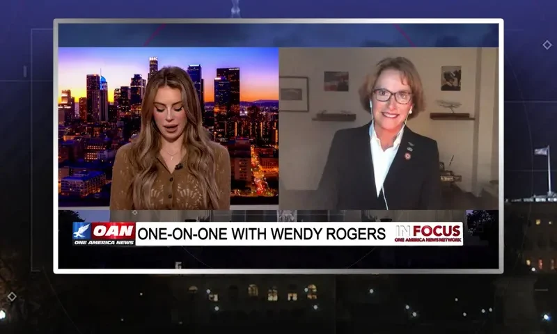 Video still from In Focus on One America News Network showing a split screen of the host on the left side, and on the right side is the guest, Wendy Rodgers.