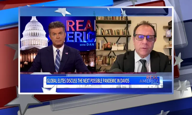 Video still from Real America on One America News Network showing a split screen of the host on the left side, and on the right side is the guest, Michael Rectenwald.