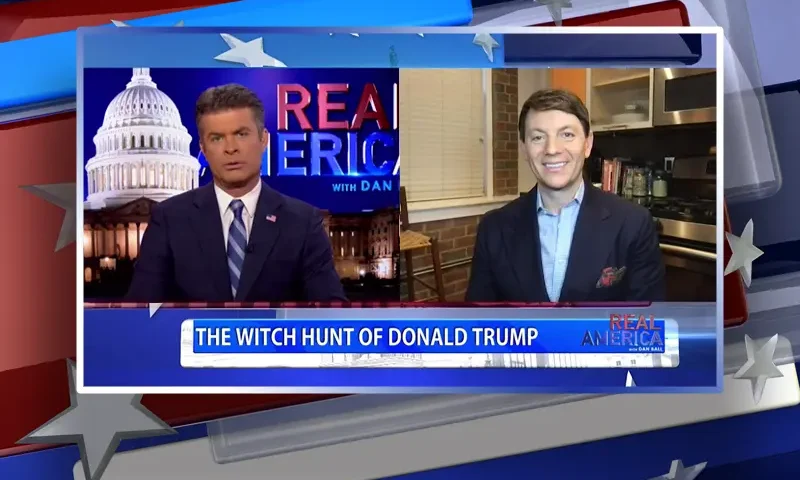 Video still from Real America on One America News Network showing a split screen of the host on the left side, and on the right side is the guest, Hogan Gidley.