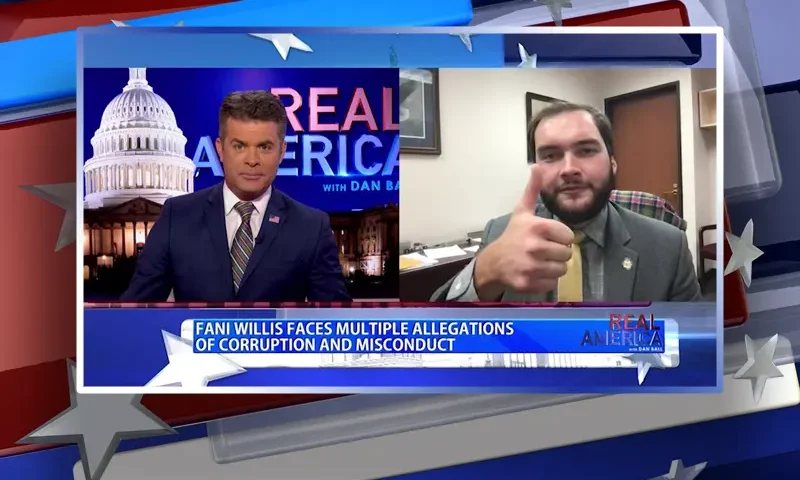 Video still from Real America on One America News Network showing a split screen of the host on the left side, and on the right side is the guest, Sen. Colton Moore.