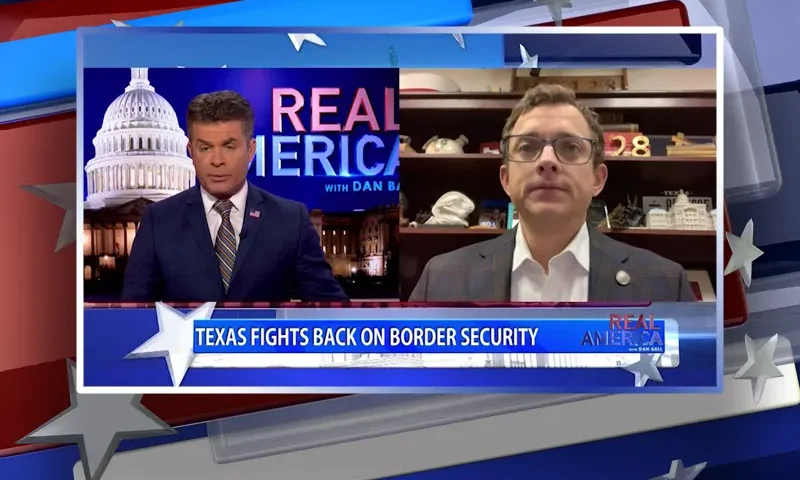 Video still from Real America on One America News Network showing a split screen of the host on the left side, and on the right side is the guest, Rep. Briscoe Cain.