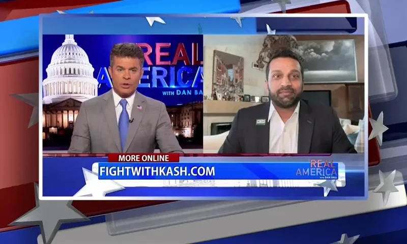 Video still from Real America on One America News Network showing a split screen of the host on the left side, and on the right side is the guest, Kash Patel.