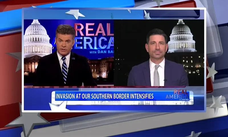 Video still from Real America on One America News Network showing a split screen of the host on the left side, and on the right side is the guest, Chad Wolf.