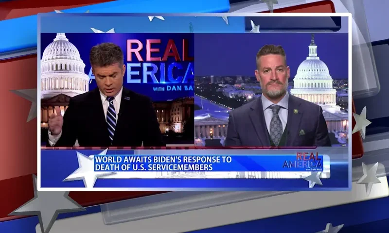 Video still from Real America on One America News Network showing a split screen of the host on the left side, and on the right side is the guest, Greg Steube.